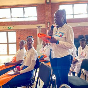 Youth events and conversations with a young lady giving a speech in a classroom